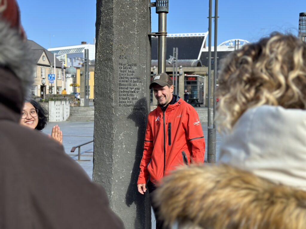 Free Walking Tour guide interacting in a tour with travellers in Reykjavik.